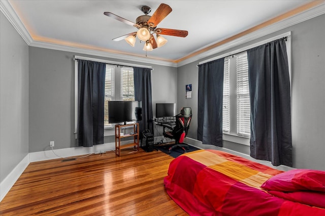 bedroom featuring crown molding, hardwood / wood-style flooring, and ceiling fan