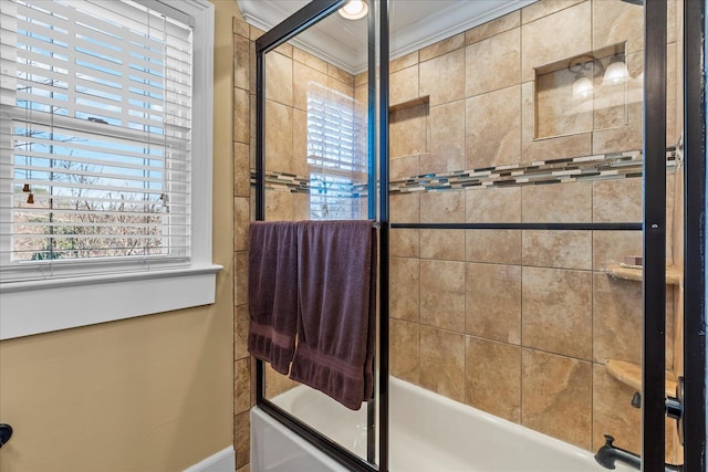 bathroom featuring bath / shower combo with glass door and ornamental molding