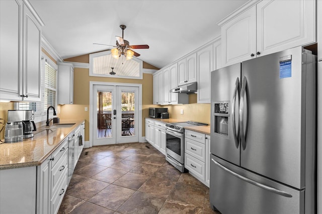 kitchen featuring sink, white cabinets, light stone counters, stainless steel appliances, and french doors