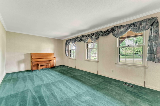 carpeted empty room with baseboards, ornamental molding, and visible vents