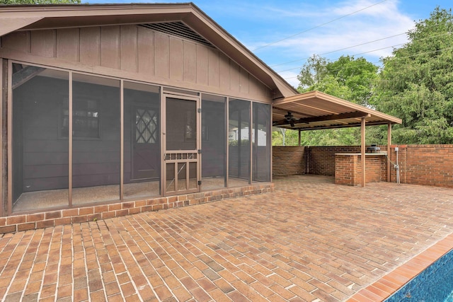 exterior space featuring a sunroom and fence