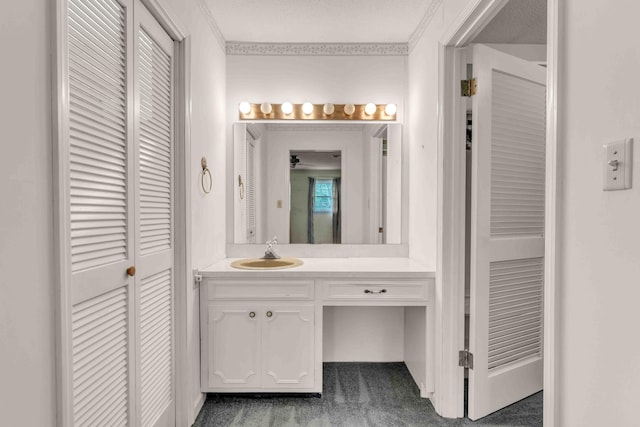 bathroom with vanity and a closet
