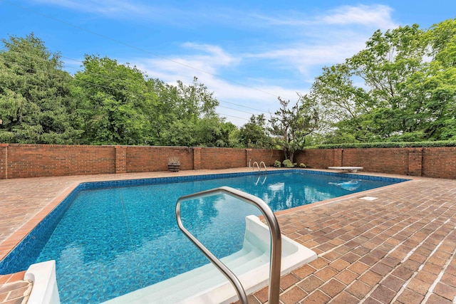 view of swimming pool featuring a patio, a fenced in pool, and a fenced backyard