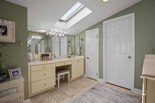 212 N Palisades Dr, Signal Mountain, TN 37377 - bathroom with a skylight, lofted ceiling, vanity, and tile patterned floors