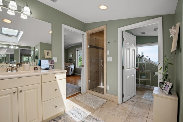 212 N Palisades Dr, Signal Mountain, TN 37377 - ensuite bathroom with a skylight, a stall shower, vanity, recessed lighting, and tile patterned flooring