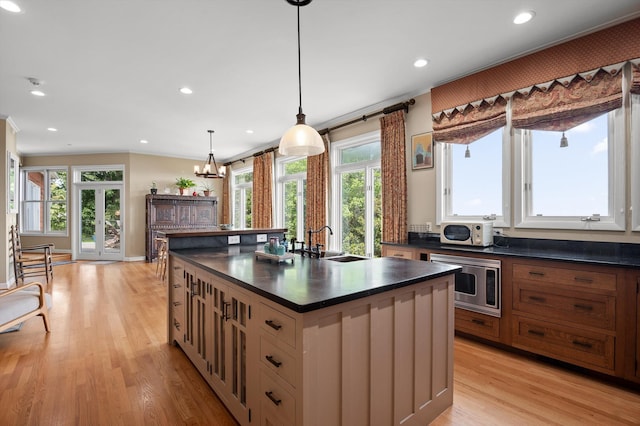 212 N Palisades Dr, Signal Mountain, TN 37377 - kitchen featuring stainless steel microwave, dark countertops, healthy amount of natural light, light wood-style floors, and recessed lighting
