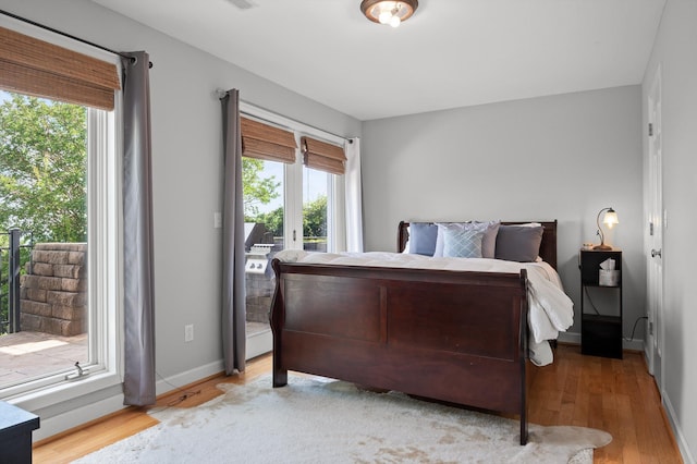 212 N Palisades Dr, Signal Mountain, TN 37377 - bedroom featuring multiple windows, access to exterior, and wood finished floors