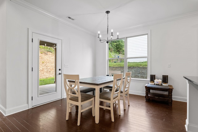 dining space featuring an inviting chandelier, dark wood-type flooring, and ornamental molding