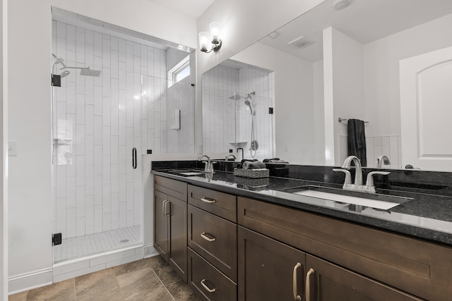 bathroom with vanity, tile patterned floors, and a shower with door