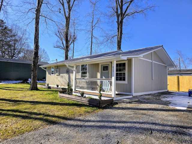 ranch-style home with covered porch and a front lawn