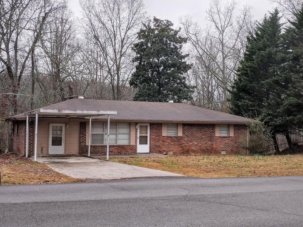 single story home featuring a carport