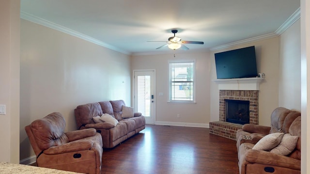 living room with ornamental molding, a brick fireplace, ceiling fan, and dark wood-type flooring