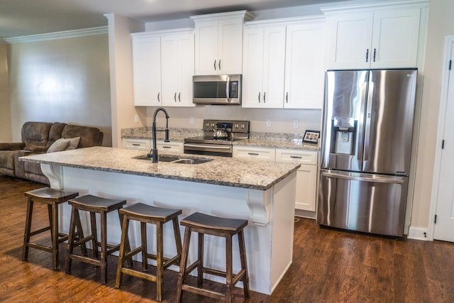 kitchen with white cabinets, appliances with stainless steel finishes, dark wood-type flooring, and sink