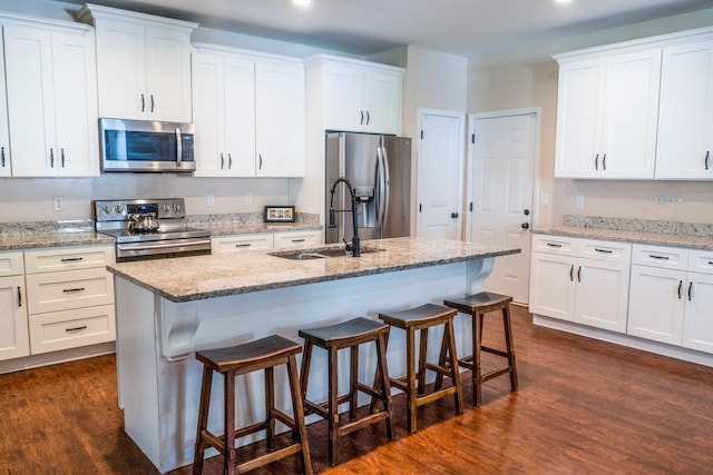 kitchen featuring white cabinetry, dark wood-type flooring, and appliances with stainless steel finishes