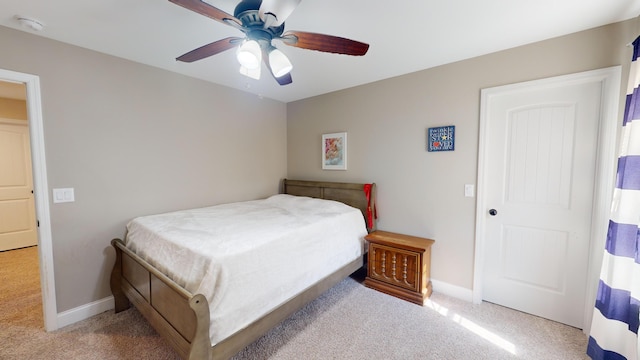 bedroom featuring light colored carpet and ceiling fan