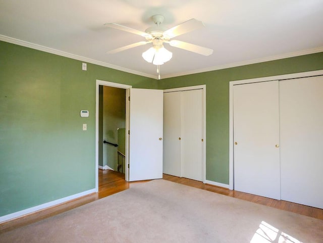 624 Pinecrest Dr, Athens, TN 37303 - unfurnished bedroom featuring crown molding, wood finished floors, baseboards, and multiple closets