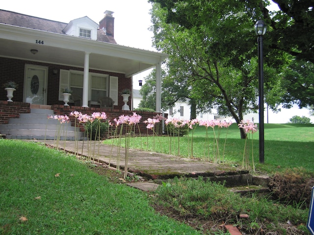 view of yard featuring covered porch