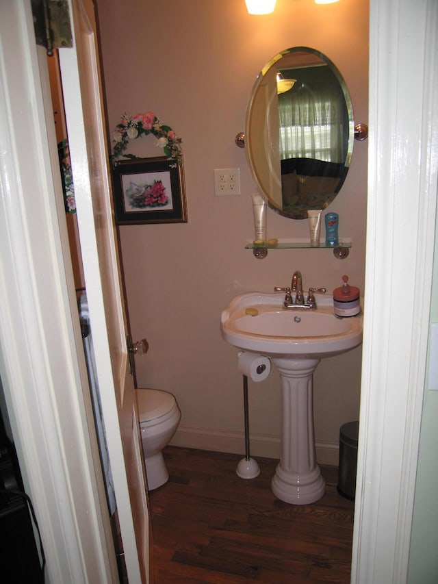 bathroom with toilet and wood-type flooring