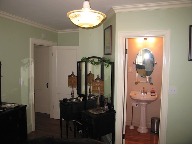 hallway with crown molding, sink, and dark hardwood / wood-style floors