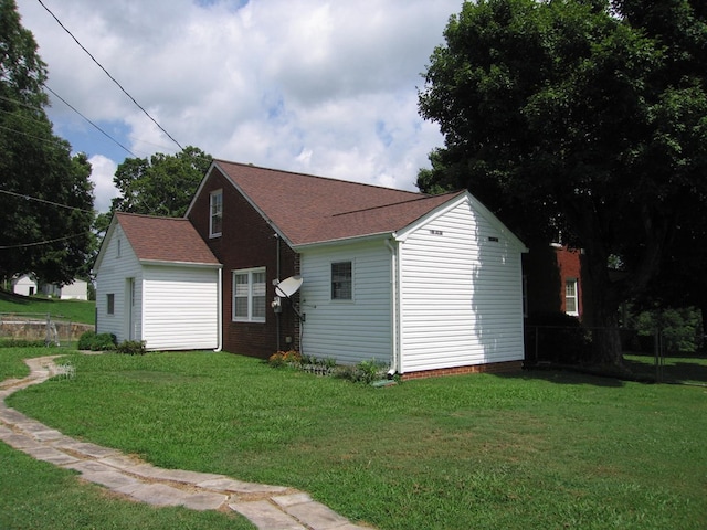 view of side of property with a yard