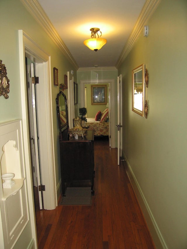 corridor with dark hardwood / wood-style flooring and crown molding