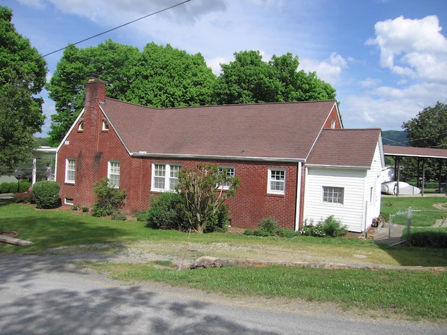 view of side of home with a lawn