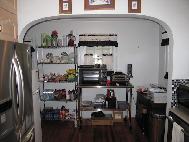 kitchen featuring hardwood / wood-style flooring and stainless steel fridge