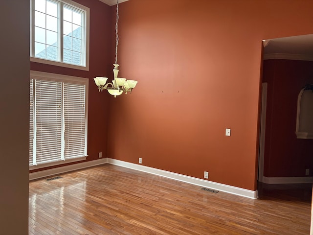 1951 Weston Hills Dr NW, Cleveland, TN 37312 - empty room with baseboards, visible vents, a notable chandelier, and wood finished floors