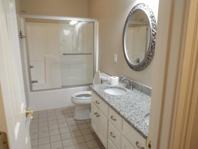 1951 Weston Hills Dr NW, Cleveland, TN 37312 - bathroom with toilet, vanity, tile patterned floors, and enclosed tub / shower combo