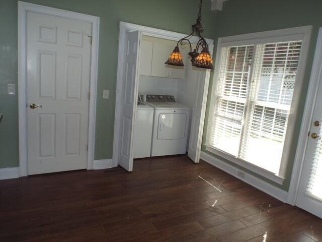 1951 Weston Hills Dr NW, Cleveland, TN 37312 - laundry area featuring washing machine and clothes dryer, dark wood-style flooring, cabinet space, and baseboards