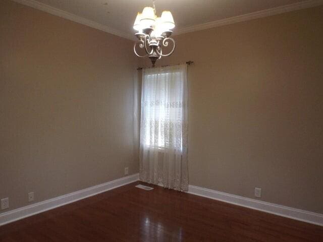 1951 Weston Hills Dr NW, Cleveland, TN 37312 - unfurnished room featuring an inviting chandelier, crown molding, baseboards, and dark wood finished floors