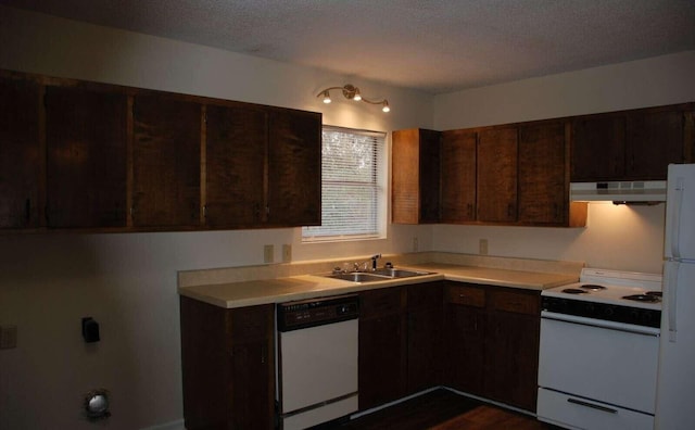 kitchen with a textured ceiling, white appliances, ventilation hood, dark brown cabinetry, and sink