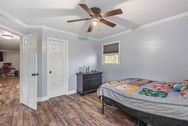 bedroom with baseboards, ornamental molding, and wood finished floors