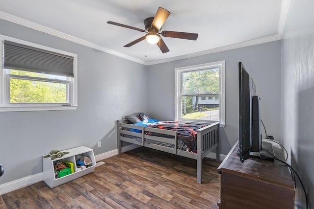 bedroom featuring wood finished floors, ornamental molding, and multiple windows