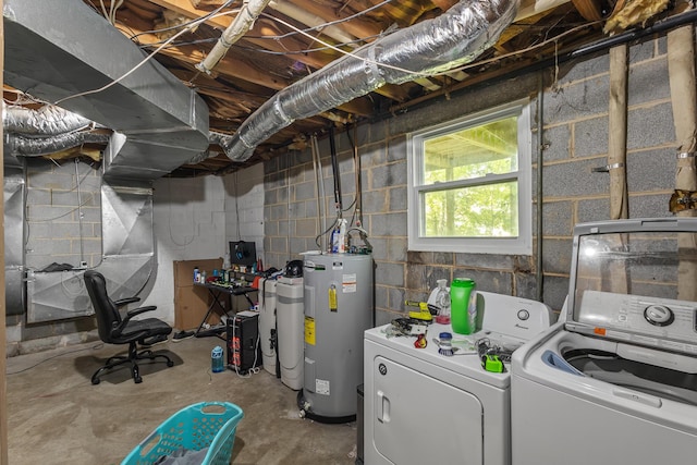 clothes washing area with washer and clothes dryer, concrete block wall, electric water heater, and laundry area