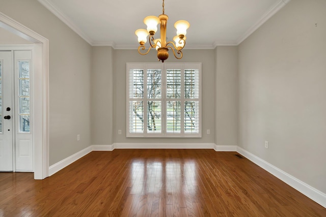 unfurnished dining area featuring baseboards, an inviting chandelier, crown molding, and hardwood / wood-style flooring