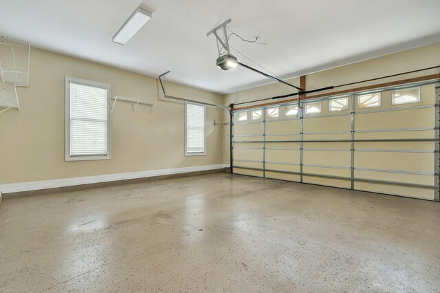 garage with a garage door opener and baseboards