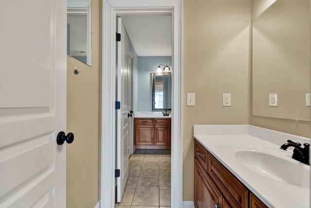 bathroom with tile patterned floors, two vanities, and a sink