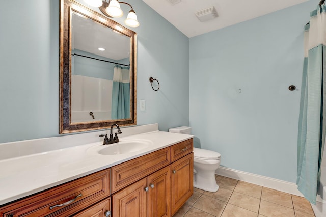 bathroom with vanity, baseboards, visible vents, tile patterned floors, and toilet