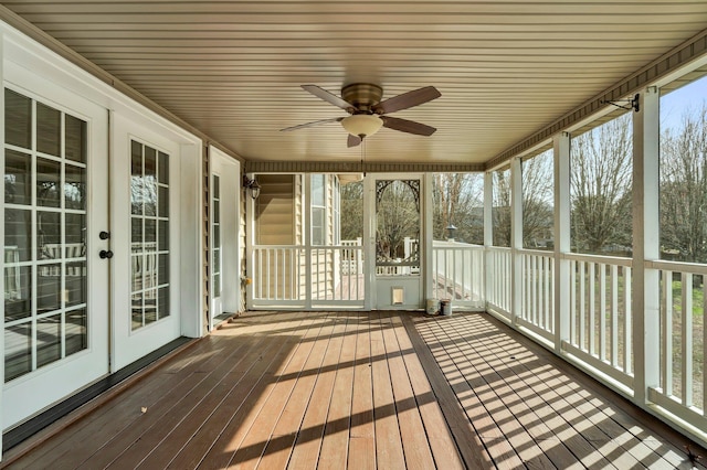 unfurnished sunroom featuring ceiling fan