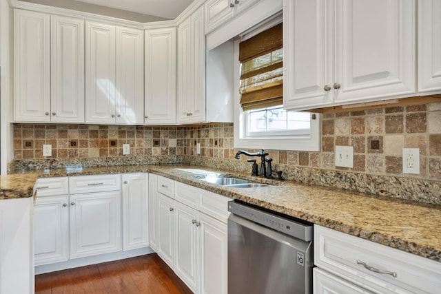 kitchen with light stone counters, dishwasher, and white cabinets