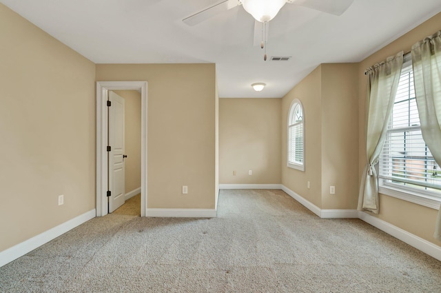 interior space featuring visible vents, baseboards, carpet, and ceiling fan