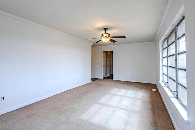 unfurnished room with ceiling fan, ornamental molding, and carpet flooring