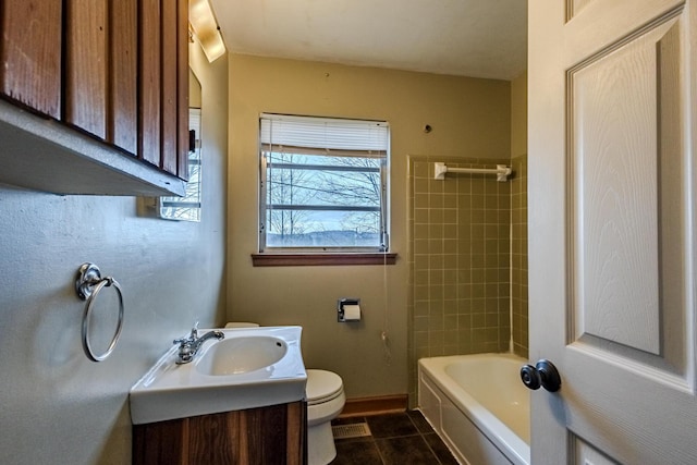 full bathroom featuring vanity, tiled shower / bath, tile patterned flooring, and toilet