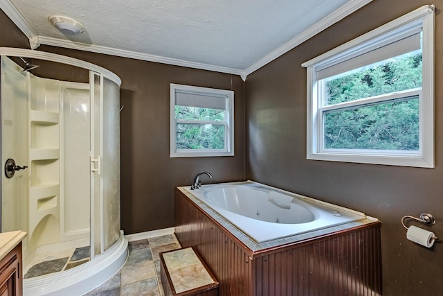 bathroom with a textured ceiling, a wealth of natural light, ornamental molding, and separate shower and tub