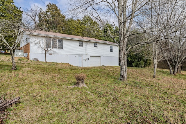 exterior space with a garage and a yard