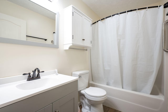 full bathroom with shower / bath combo with shower curtain, vanity, a textured ceiling, and toilet