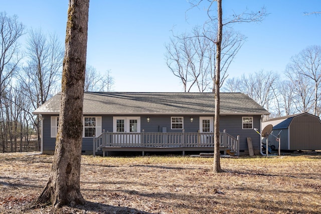 ranch-style home featuring a shed and a wooden deck