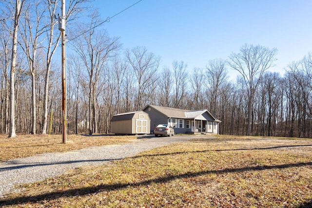 view of front of house featuring covered porch and a storage shed