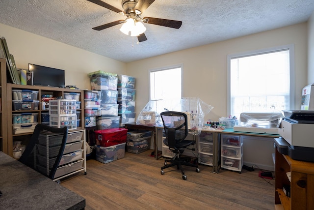 office area featuring ceiling fan, dark hardwood / wood-style flooring, and a textured ceiling